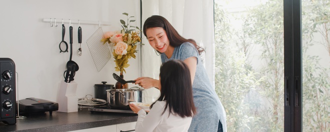 young asian japanese mom daughter cooking home lifestyle women happy making pasta spaghetti together breakfast meal modern kitchen house morning